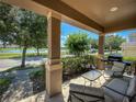 Charming covered porch with outdoor seating, perfect for enjoying the serene water view at 12795 Bosworth Ave, Windermere, FL 34786