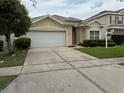 Well-maintained home with a spacious driveway and manicured landscaping at 1574 Derby Glen Dr, Orlando, FL 32837