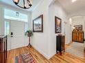 Inviting foyer with hardwood floors, elegant lighting, and decor that leads into the main living spaces at 1640 Mayfield Ave, Winter Park, FL 32789