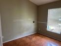 Bedroom featuring tile floors, a window, and ample natural light at 1809 Elm Ridge Ct, Orlando, FL 32808
