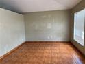 Spacious living room featuring tile floors and natural light from the window at 1809 Elm Ridge Ct, Orlando, FL 32808
