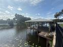 Picturesque dock on the water with a covered boat lift at 1811 Missouri Ave, Sanford, FL 32771