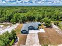 Stunning aerial view of a single-story home surrounded by lush greenery and trees at 1845 Springhead Dr, Deltona, FL 32725