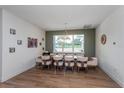 Elegant dining room with a large window, stylish furnishings, and warm, inviting decor at 1845 Springhead Dr, Deltona, FL 32725