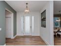 Bright entryway featuring wood-look tile flooring, decorative accents, and a modern front door at 1845 Springhead Dr, Deltona, FL 32725