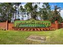 Welcoming Highlands Reserve Golf Community sign, with brick base and manicured landscaping at 204 Birkdale St, Davenport, FL 33897
