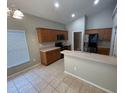 Well-lit kitchen with tile flooring, wood cabinets, and stainless steel appliances at 2131 Kaylas Ct, Orlando, FL 32817
