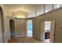 Spacious living room featuring neutral colors and arched doorways, offering a versatile living space at 2131 Kaylas Ct, Orlando, FL 32817