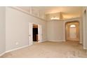 Spacious living room featuring soaring ceilings, neutral carpeting, and arched doorways at 2131 Kaylas Ct, Orlando, FL 32817