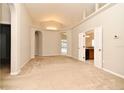 Open-concept living room featuring neutral carpet, arched doorways, and natural light at 2131 Kaylas Ct, Orlando, FL 32817