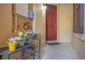 Inviting red front door area with decorative metal flower stand on a cozy porch at 2261 Brookridge Trl, Sanford, FL 32773