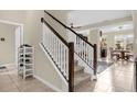 Bright and spacious staircase leading to the upper level with views of the open-concept living area at 2261 Brookridge Trl, Sanford, FL 32773