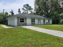Single story home featuring a white brick facade, and a well-manicured front yard at 2417 Yale Ave, Sanford, FL 32771