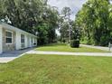 View of the home's manicured lawn and the surrounding neighborhood street at 2417 Yale Ave, Sanford, FL 32771