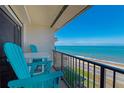 Balcony with ocean view and chairs on a sunny day at 2700 Ocean Shore Blvd # 515, Ormond Beach, FL 32176
