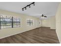 Open living room featuring wood-look flooring, ample natural light, a ceiling fan, and track lighting at 3016 Rogan Rd, Orlando, FL 32812