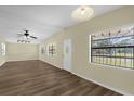 Bright living room features wood-look floors, multiple windows, ceiling fan, and track lighting at 3016 Rogan Rd, Orlando, FL 32812
