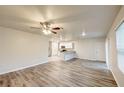 Bright living room featuring wood-look floors, and an open concept design to the kitchen and dining area at 3354 Summerdale Way, Kissimmee, FL 34746