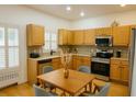Well-lit kitchen with wood cabinets, stainless steel appliances, and an adjacent dining area at 340 Sorrento Rd, Kissimmee, FL 34759
