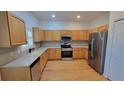 Charming kitchen featuring stainless steel appliances, light quartz countertops, and hardwood floors at 340 Sorrento Rd, Kissimmee, FL 34759