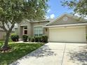 Well-maintained house with a two-car garage and landscaped front yard at 3539 Maple Ridge Loop, Kissimmee, FL 34741