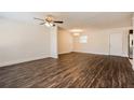 Open-concept living room featuring stylish dark wood flooring, ceiling fan and modern lighting at 4 Kasey Dr, Orlando, FL 32807