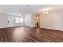 Bright living room with dark wood flooring, ample natural light, and updated fixtures at 4 Kasey Dr, Orlando, FL 32807