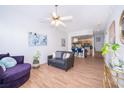 Inviting living room with modern decor, wood-look tile floors, and an open layout to the kitchen at 4011 Venetian Bay Dr # 103, Kissimmee, FL 34741