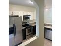 Kitchen featuring white cabinets, stainless steel appliances, and granite countertops at 454 Wilton Cir, Sanford, FL 32773