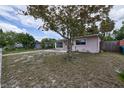A charming single story home situated on a lot with a mature tree, visible from the street at 535 Romano Ave, Orlando, FL 32807