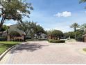 Gated entrance to the community with brick accents and manicured landscaping at 650 Shropshire Loop, Sanford, FL 32771