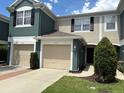 Charming townhome featuring a one-car garage and inviting facade with lush landscaping at 650 Shropshire Loop, Sanford, FL 32771