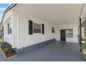 View of carport featuring painted concrete flooring and exterior storage for outdoor living at 814 Roseapple Ave, Lady Lake, FL 32159