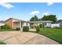 Inviting single-story home featuring a manicured lawn and tidy landscaping at 830 Hawkes Ave, Orlando, FL 32809