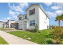 Attractive two-story home showcasing a brick driveway and well-manicured landscaping at 9027 Coral Cape St, Kissimmee, FL 34747