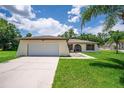Well-maintained single-story home with attached garage and inviting front yard at 909 Hendon Place, Kissimmee, FL 34758