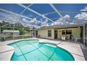 Inviting screened-in pool area, with grill, table, and lounge chairs, perfect for relaxation at 909 Hendon Place, Kissimmee, FL 34758
