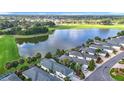 An aerial view showcasing the home's desirable location near a lake and golf course in a neighborhood at 1008 Jackson St, The Villages, FL 32162