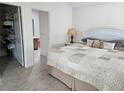 Cozy bedroom with a neutral color palette and an open closet at 1008 Jackson St, The Villages, FL 32162