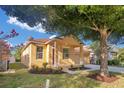 Inviting front exterior showcasing a well-maintained lawn and covered porch at 10580 Moss Rose Way, Orlando, FL 32832