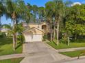 Well maintained two-story home featuring a two car garage, neutral paint, mature landscaping, and brick driveway at 1130 Burland Cir, Winter Garden, FL 34787