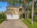 Well maintained two-story home featuring a two car garage, neutral paint, and well kept landscaping at 1130 Burland Cir, Winter Garden, FL 34787