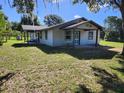 Charming single-story home featuring a covered porch, neutral siding, and a well-maintained lawn in a tranquil setting at 13208 Massachusetts Ave, Astatula, FL 34705