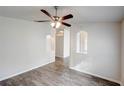 Bright living room featuring modern ceiling fan and stylish gray wood-look flooring at 1373 Burnley Ct, Kissimmee, FL 34758
