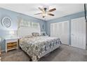 Comfortable bedroom with neutral carpet, white furniture, ceiling fan, and closet at 141 N Hill Ave # 141, Deland, FL 32724
