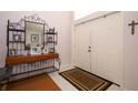 Foyer with white double door entrance and table with mirror and space for decor at 1546 Royal Cir, Apopka, FL 32703