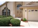Up close view of home's entrance with arched window, double doors, and 1546 address at 1546 Royal Cir, Apopka, FL 32703