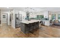 Spacious kitchen features a large island with seating, stainless steel appliances, and modern white cabinetry at 1795 Markham Glen Cir, Longwood, FL 32779