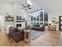 Bright living room with soaring ceilings, stunning brick fireplace, and large windows create a cozy and inviting space at 1795 Markham Glen Cir, Longwood, FL 32779