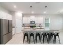 Bright kitchen with a granite island, black bar stools and stainless steel appliances at 1997 Standing Rock Cir, Oakland, FL 34787